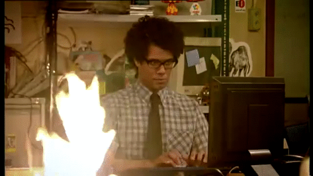 animated gif of Moss from The IT Crowd working while his desk is on fire