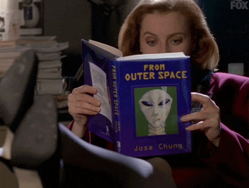gif of Scully from the X-Files reading a book about aliens