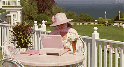 gif of a woman laughing evilly at a pink laptop